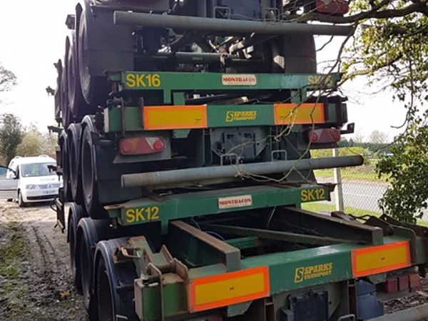 stacked up green skeleton trailers from rear